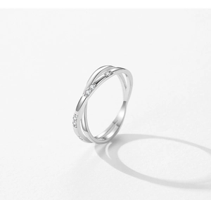 Macro detail of S925 sterling silver crisscross ring with sparkling cubic zirconia inlay