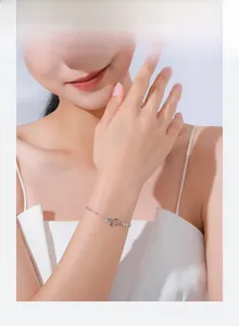 Close-up of minimalist s925 silver bracelet featuring interlocking double rings on wrist