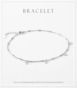 Detail of 925 sterling silver chain bracelet featuring hollow heart charms and lobster clasp