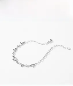Detail of s925 silver bracelet featuring heart charms and pave-set cubic zirconia accents