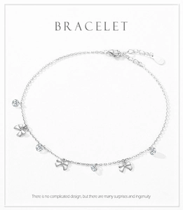 Detail of S925 sterling silver bow bracelet with sparkling zircons and lobster clasp