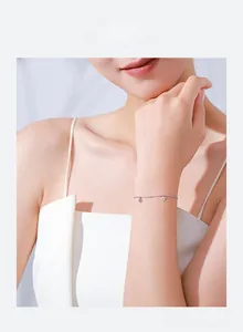 Minimalist 925 sterling silver lip charm bracelet worn on a female wrist for daily style