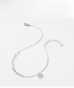 Detail of S925 sterling silver bow pendant with asymmetric splice chain necklace