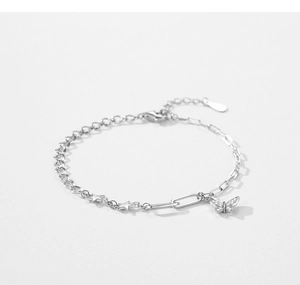 Macro detail of S925 silver bracelet featuring cubic zirconia butterfly and star charms