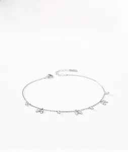 Detail of S925 sterling silver bracelet with bow charms and sparkling zircon stones