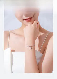 Close-up of elegant S925 silver flower bracelet with pink zircon on a model's wrist
