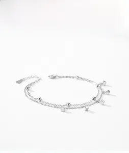Detail of silver double-layer bracelet with geometric cube charms and small beads