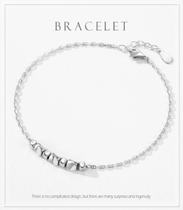 Detail of adjustable S925 sterling silver chain bracelet with polished geometric beads