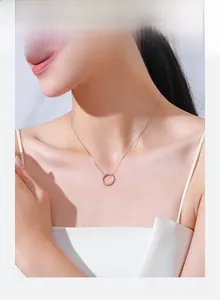 Close-up of a s925 silver minimalist hollow circle necklace worn by a female model