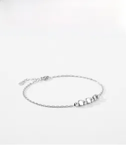 Detailed shot of an S925 sterling silver chain bracelet with five irregular metal beads