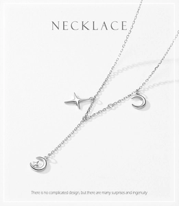 Detail view of S925 silver necklace featuring star and moon pendants on a thin chain