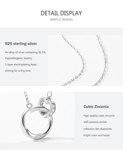 Macro detail of S925 sterling silver chain with interlocking heart and CZ ring pendant
