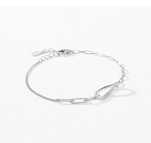 Detailed macro view of S925 sterling silver asymmetrical paperclip and curb link bracelet