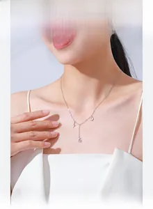 Close-up of S925 silver star and moon pendant necklace on a model's neckline