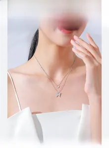 Elegant double-layer S925 silver necklace with sparkling zircon butterfly pendant on model