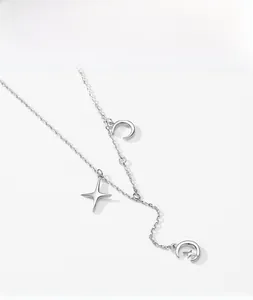 Detail of S925 sterling silver necklace with delicate star and moon crescent pendants