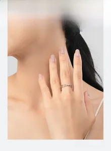 Close-up of S925 silver criss-cross ring with micro-paved cubic zirconia worn on hand