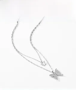 Detail of silver S925 butterfly necklace with double layered chains and zircon pavé charms