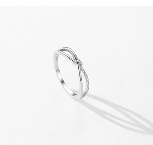 Macro detail of S925 sterling silver stamp on minimalist geometric criss-cross ring