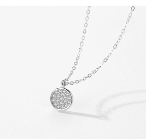 Macro shot of S925 sterling silver necklace with sparkling pave round pavé pendant