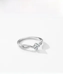 Detail of S925 silver ring with 1 carat round gemstone and twisted pavé diamond band