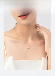 Close-up of minimalist S925 sterling silver heart pendant necklace on woman neck