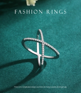 Macro detail of S925 silver X-shaped crisscross ring with micro-pave zircon crystals