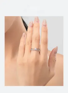 Close-up of s925 silver crown ring with square main diamond worn on woman finger