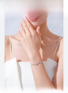 Detail of S925 silver flower bracelet with sparkling crystals on a female wrist