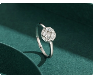 Macro shot of silver ring featuring rectangle cut stones and pavé setting on green texture