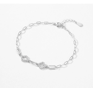 Detail of silver clover bracelet with paperclip chain and sparkling micro-pave zircons