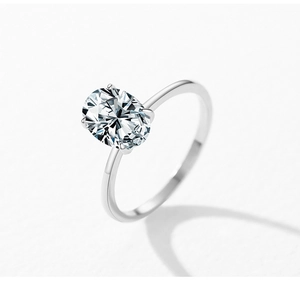 Macro shot of oval-cut solitaire stone in classic four-prong silver setting