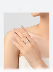 Close-up of a s925 silver oval cut diamond ring worn on a finger in soft natural light