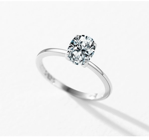 Close-up of S925 hallmark on polished silver band with oval cut solitaire stone