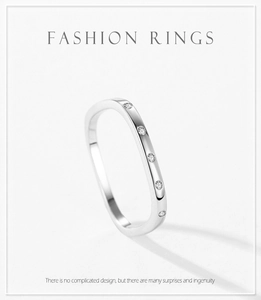Detail of a minimalist 925 sterling silver ring featuring five inlaid round zircon stones