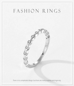 Close-up of S925 sterling silver wavy ring featuring sparkling pavé set stones and engraving