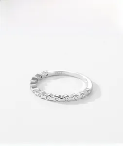 Macro detail of S925 sterling silver wavy ring with small zircons and S925 hallmark