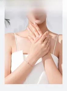 Close-up of a minimalist S925 sterling silver round crystal bracelet on a woman's wrist
