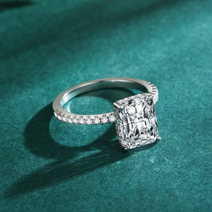 Silberring mit rechteckigem Radiant-Schliff und Pavé-Besatz auf dunkelgrünem Grund