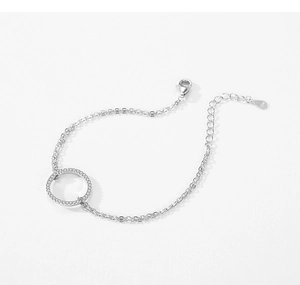 Close-up of S925 sterling silver double chain bracelet with micro-pave zirconia ring charm