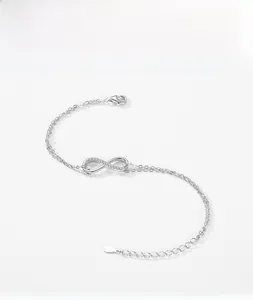 Macro view of S925 sterling silver infinity bracelet with pavé cubic zirconia and lobster clasp