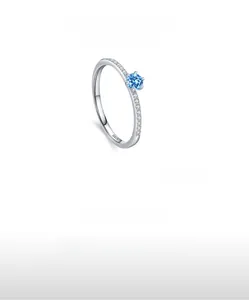 Detailed macro of S925 silver ring with blue zircon and pavé set white stones
