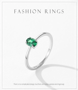 Macro detail of oval green emerald zircon set in S925 sterling silver minimalist ring