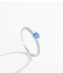 Macro side view of S925 silver ring featuring blue zircon and six-prong setting