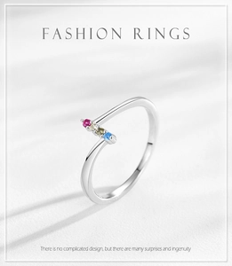 Close-up of silver open ring with colorful rainbow zircon stones in a minimalist design