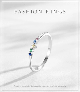 Close-up of S925 silver ring featuring five colorful zircon stones on a silk background