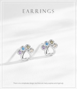 Detail of S925 silver paw studs with colorful rainbow zircon heart-shaped accents