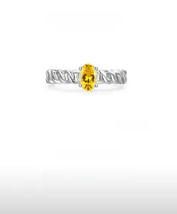 Detail of S925 silver ring featuring a yellow oval zircon and braided texture band