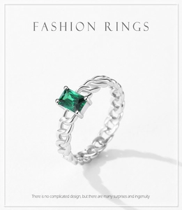Macro shot of S925 sterling silver chain ring with emerald rectangular cut gemstone
