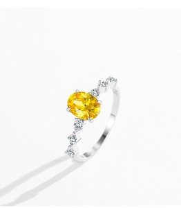 Detail of S925 silver ring featuring an oval yellow zircon and side diamond accents